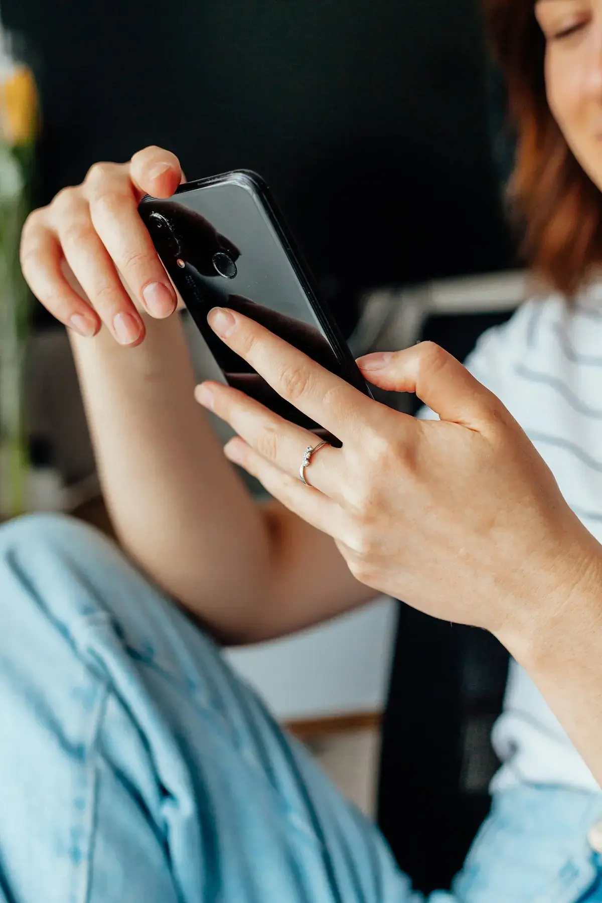 A person holding a smartphone, about to search for a local business